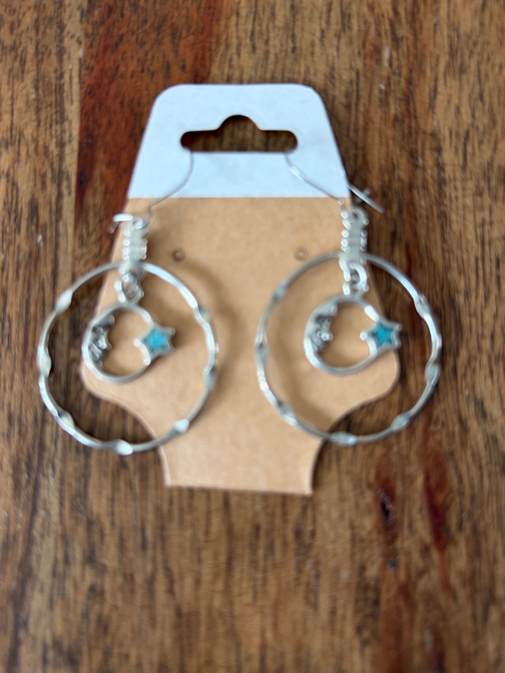 Silver toned celestial hoop Earrings featuring a crescent moon and star accent